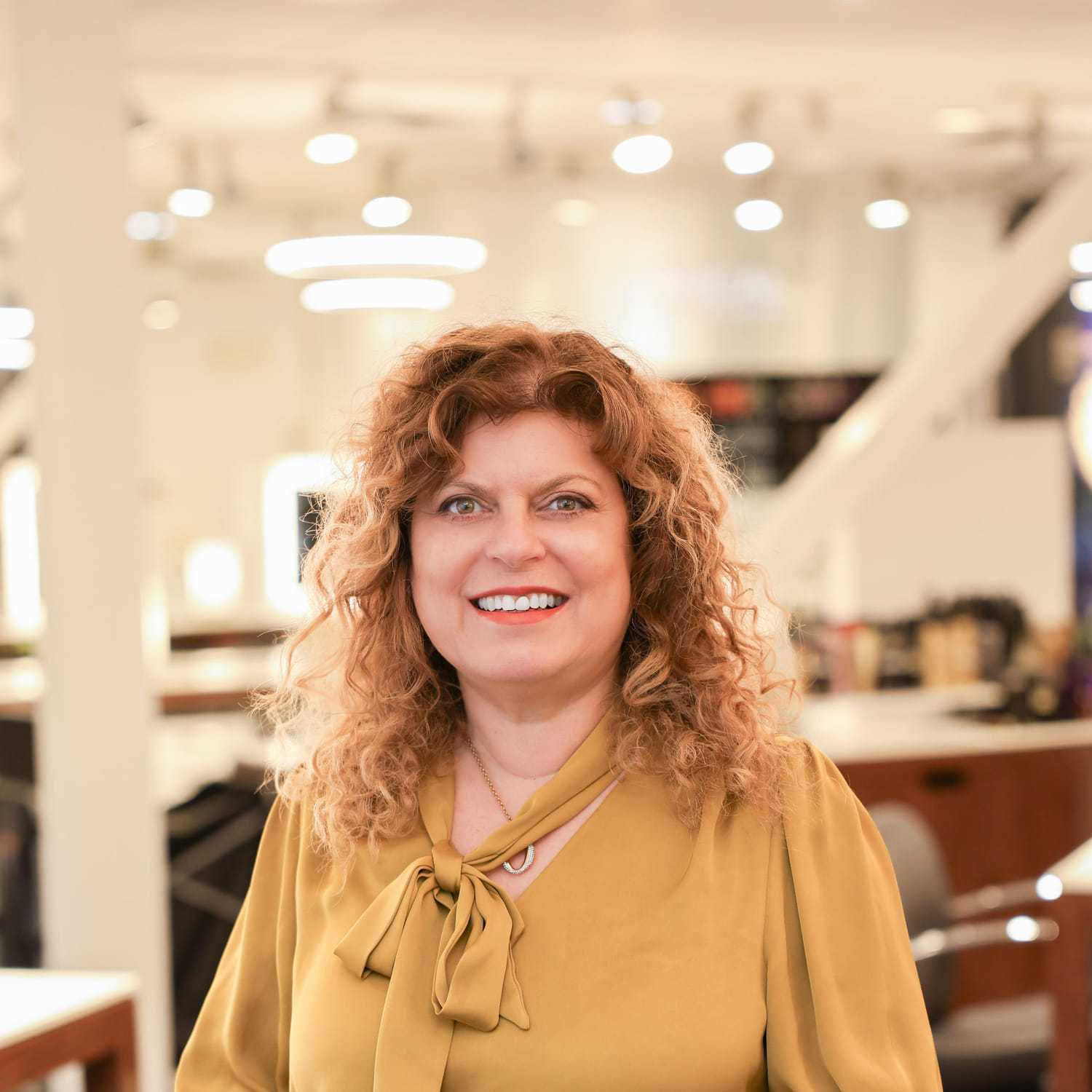 Portrait of Maria, a professional stylist at Esmeralda’s Beauty Bar, showcasing their expertise and style.