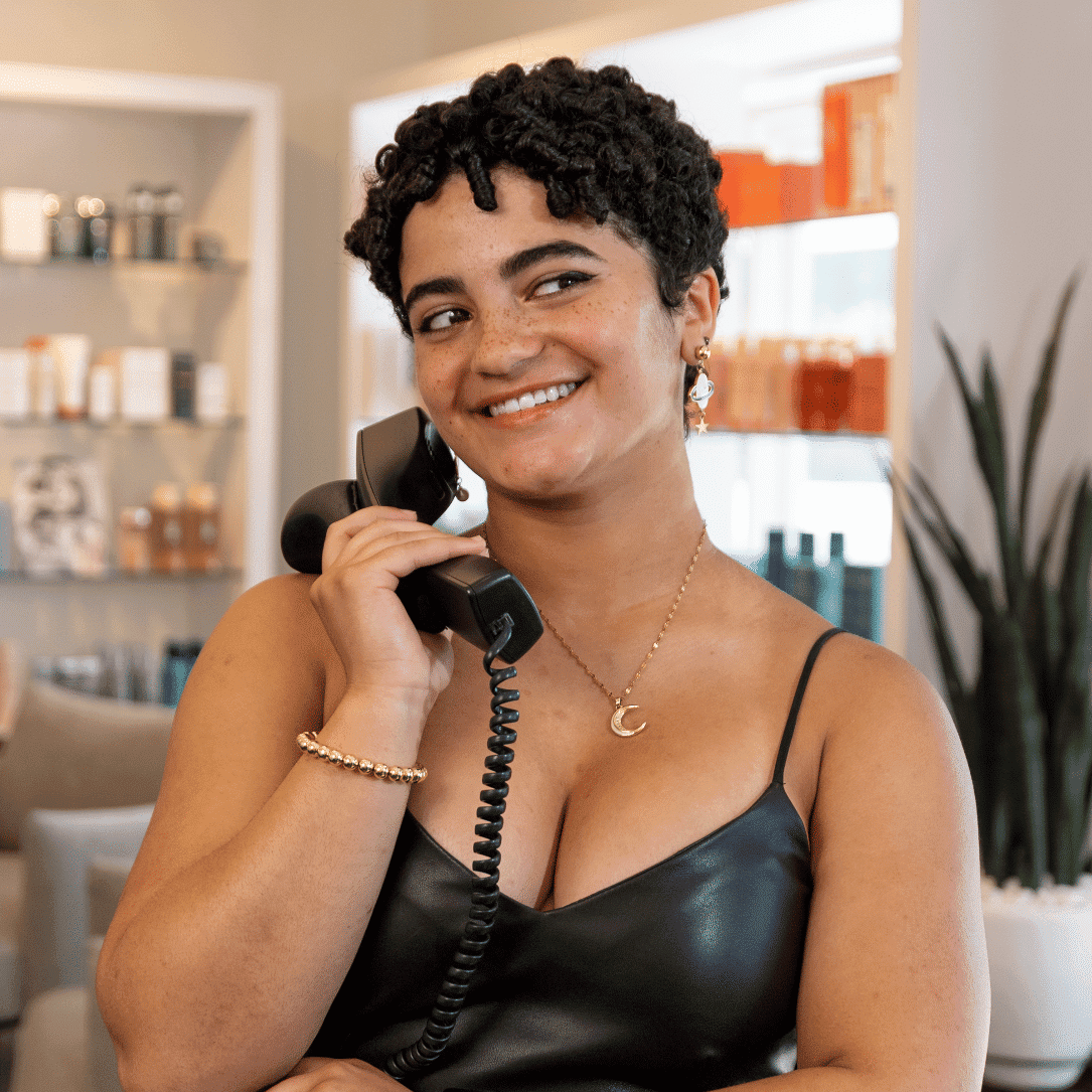 Portrait of Audrey, a professional stylist at Esmeralda’s Beauty Bar, showcasing their expertise and style.