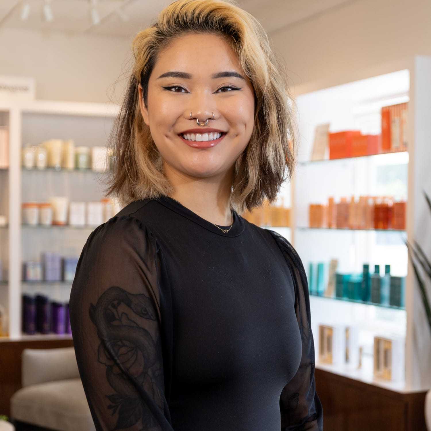 Portrait of Mayson, a professional stylist at Esmeralda’s Beauty Bar, showcasing their expertise and style.